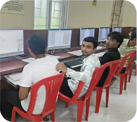 Students learning accounting software with instructor support in lab setup